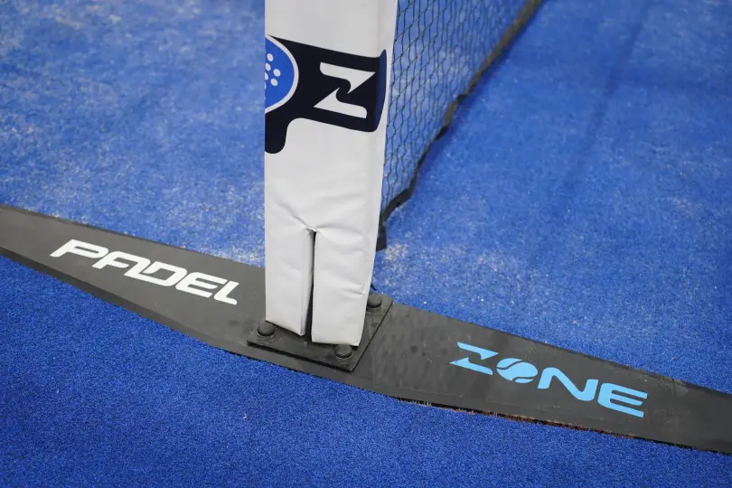 Padel Zone net post on blue Mondo turf